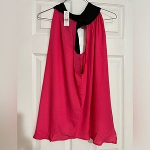 Fushia lengthy top drop down with a black halter setting in the back.